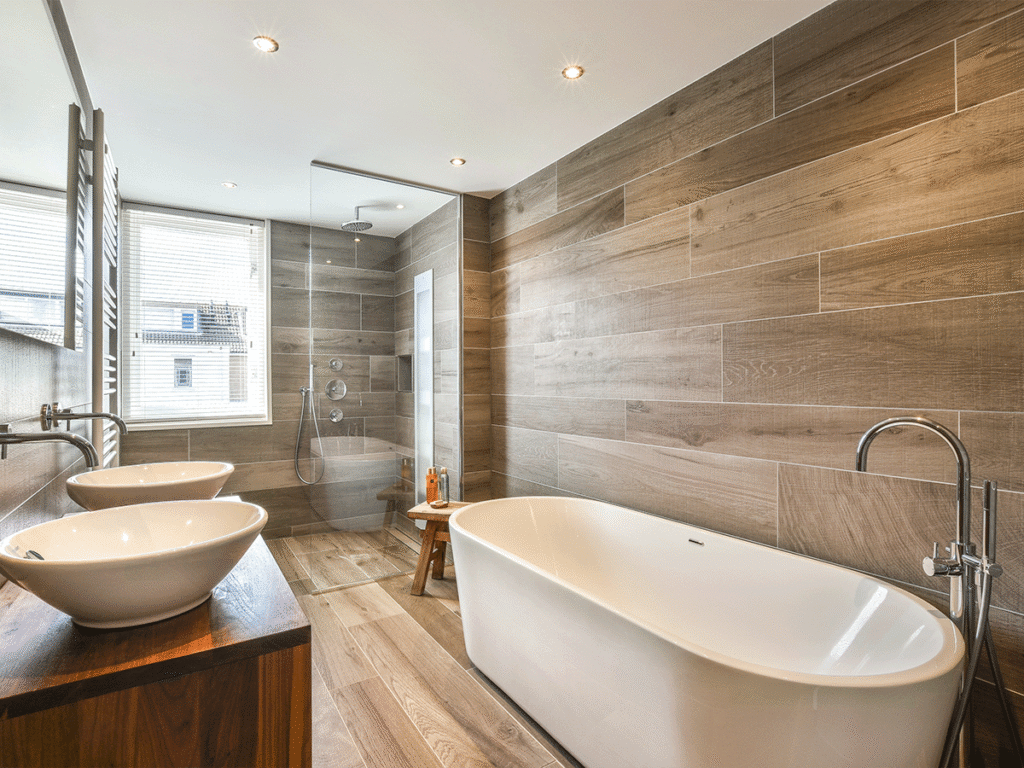 Een badkamer waarin we de ronde vormen zien terugkomen in de wasbakken en het bad, deze zijn geplaats is een luxe badkamer